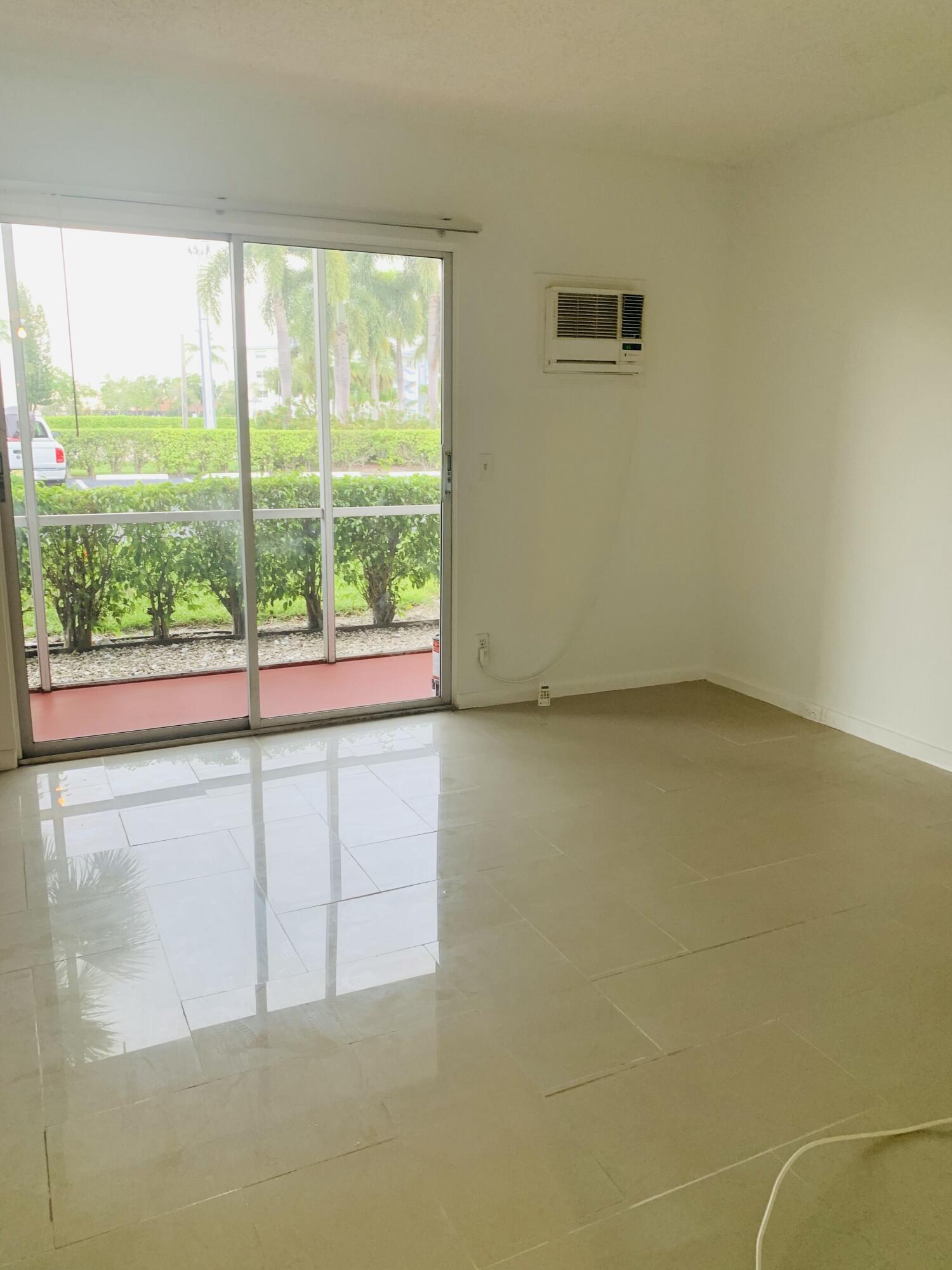 7 Suffolk A Boca Raton, FL 33434 - Photo 8 of 19 a view of an empty room and a window