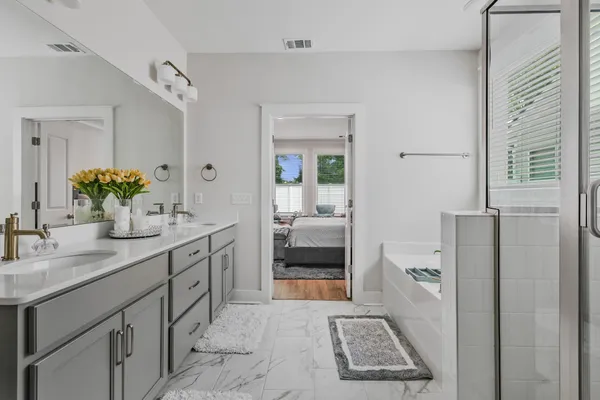 a bathroom with a sink a toilet and shower