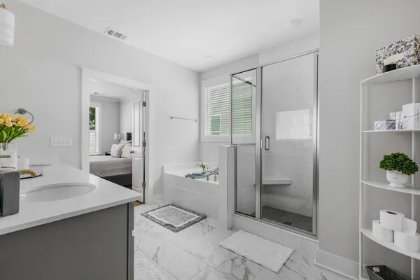a bathroom with a shower sink and mirror