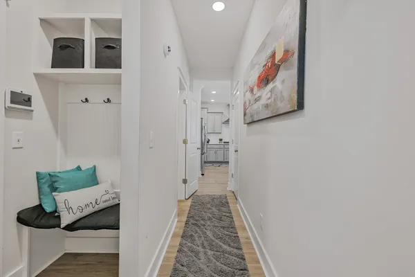 a hallway with furniture and wooden floor