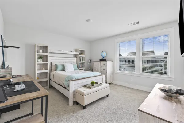 a bedroom with a bed and a window