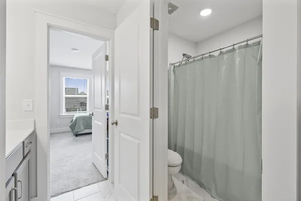 a bathroom with a shower and a toilet