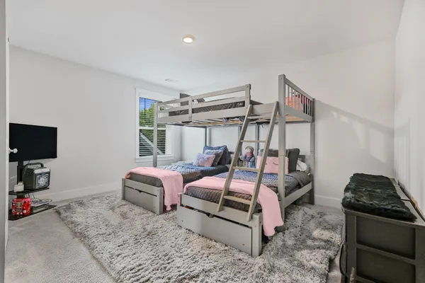 a bedroom with furniture and a flat screen tv