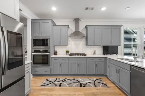 a kitchen with a sink a refrigerator and cabinets