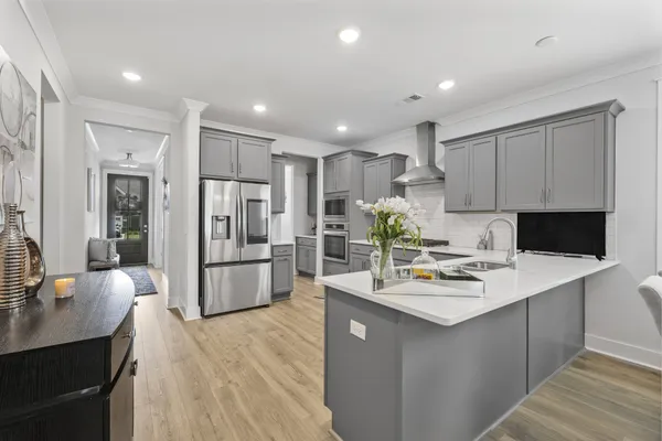 a kitchen with refrigerator and cabinets
