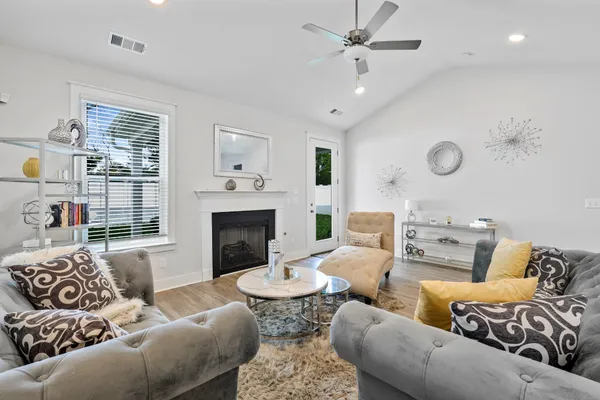 a living room with furniture fireplace and a large window