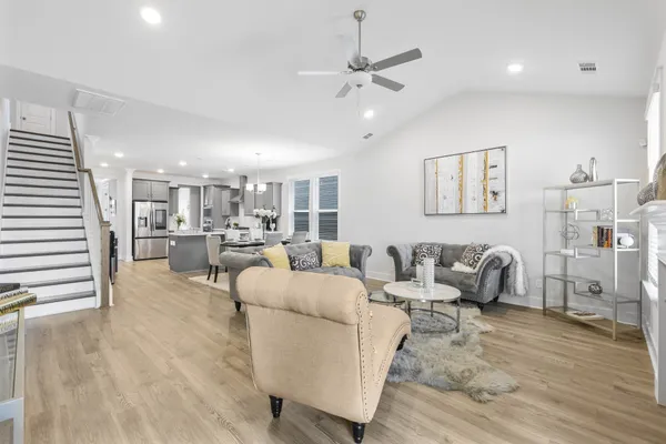 a living room with furniture and kitchen view