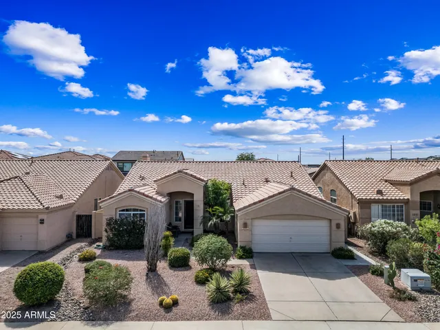 a living room with furniture chandelier and a window
