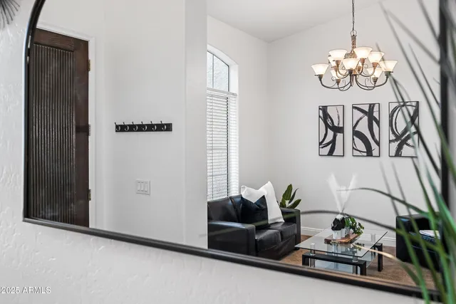 a kitchen with stainless steel appliances kitchen island granite countertop a refrigerator a stove a sink a dining table and chairs with wooden floor