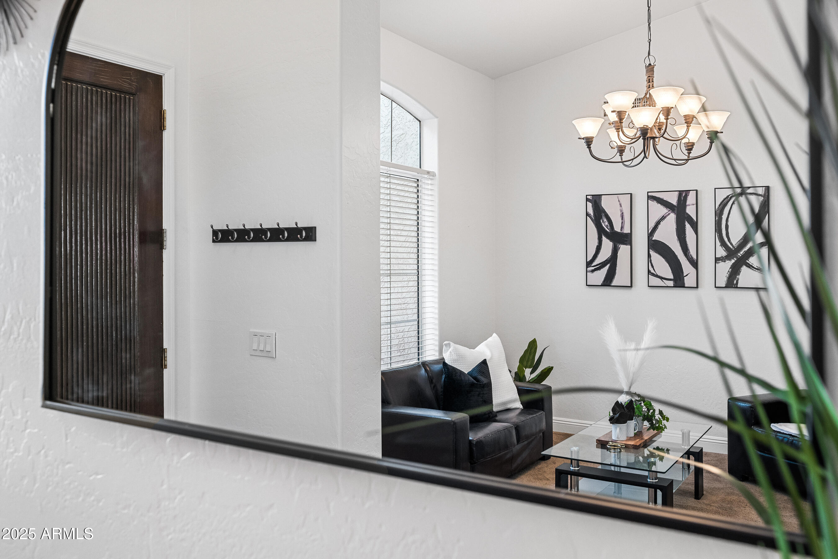 1541 West Chilton Avenue Gilbert, AZ 85233 - Photo 9 of 71 a living room with furniture and a chandelier