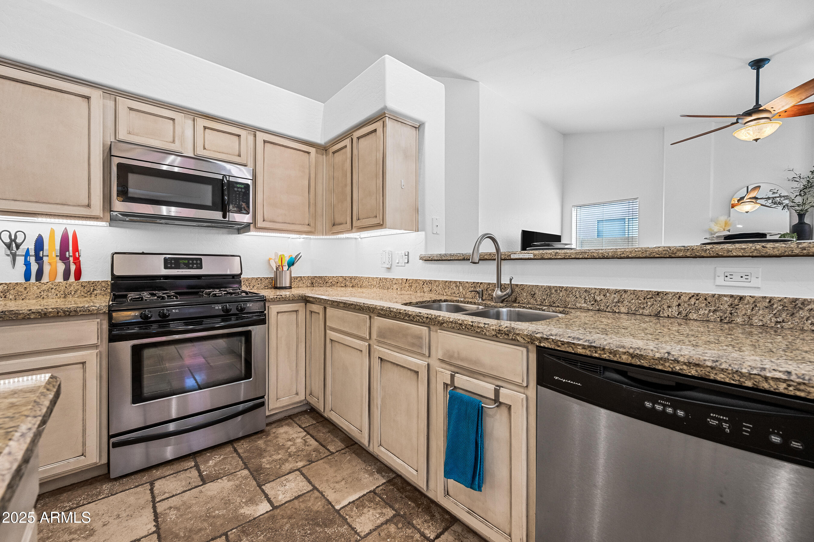 1541 West Chilton Avenue Gilbert, AZ 85233 - Photo 16 of 71 a kitchen with stainless steel appliances granite countertop a stove microwave and sink