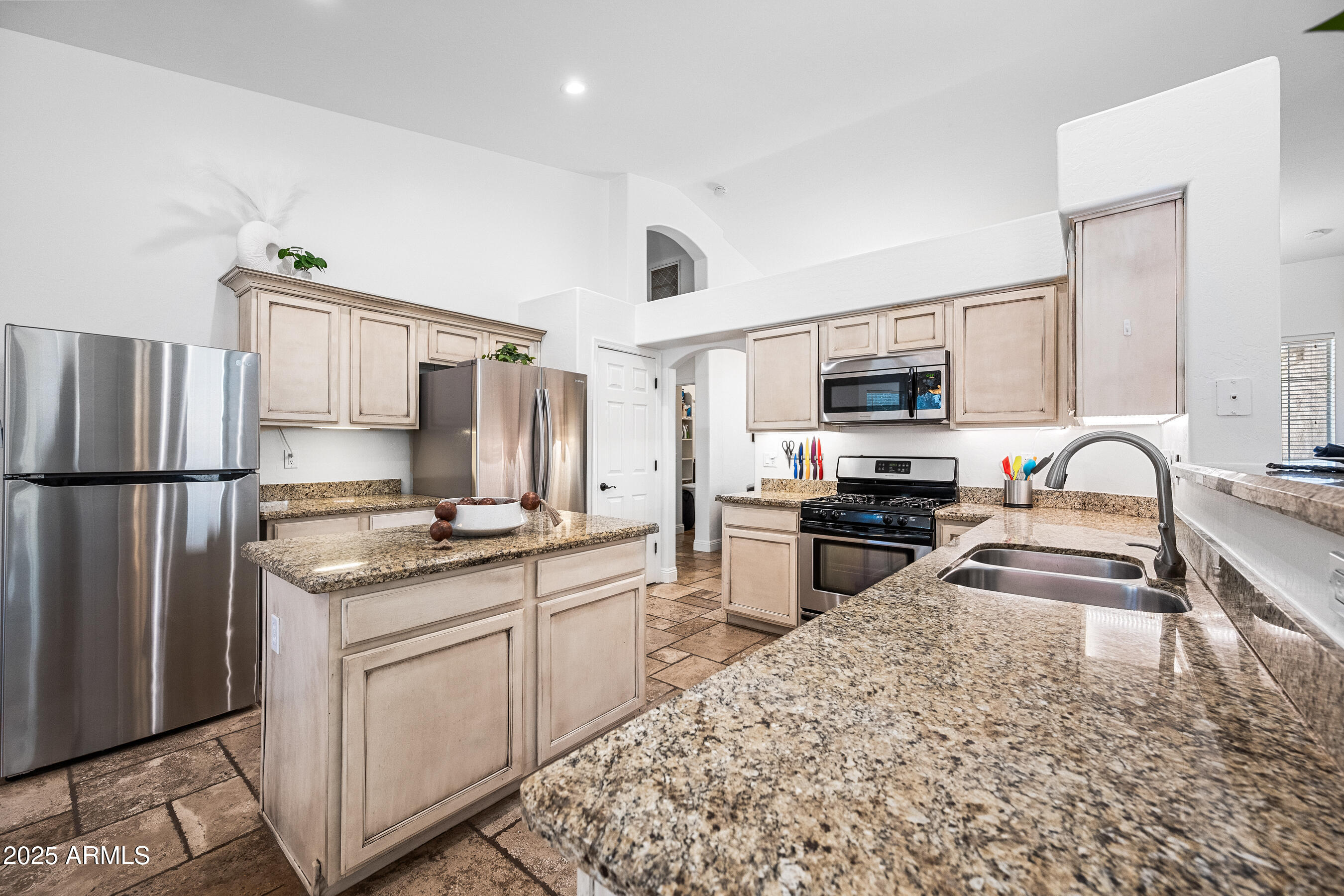 1541 West Chilton Avenue Gilbert, AZ 85233 - Photo 17 of 71 a kitchen with stainless steel appliances granite countertop a stove top oven a sink refrigerator and microwave