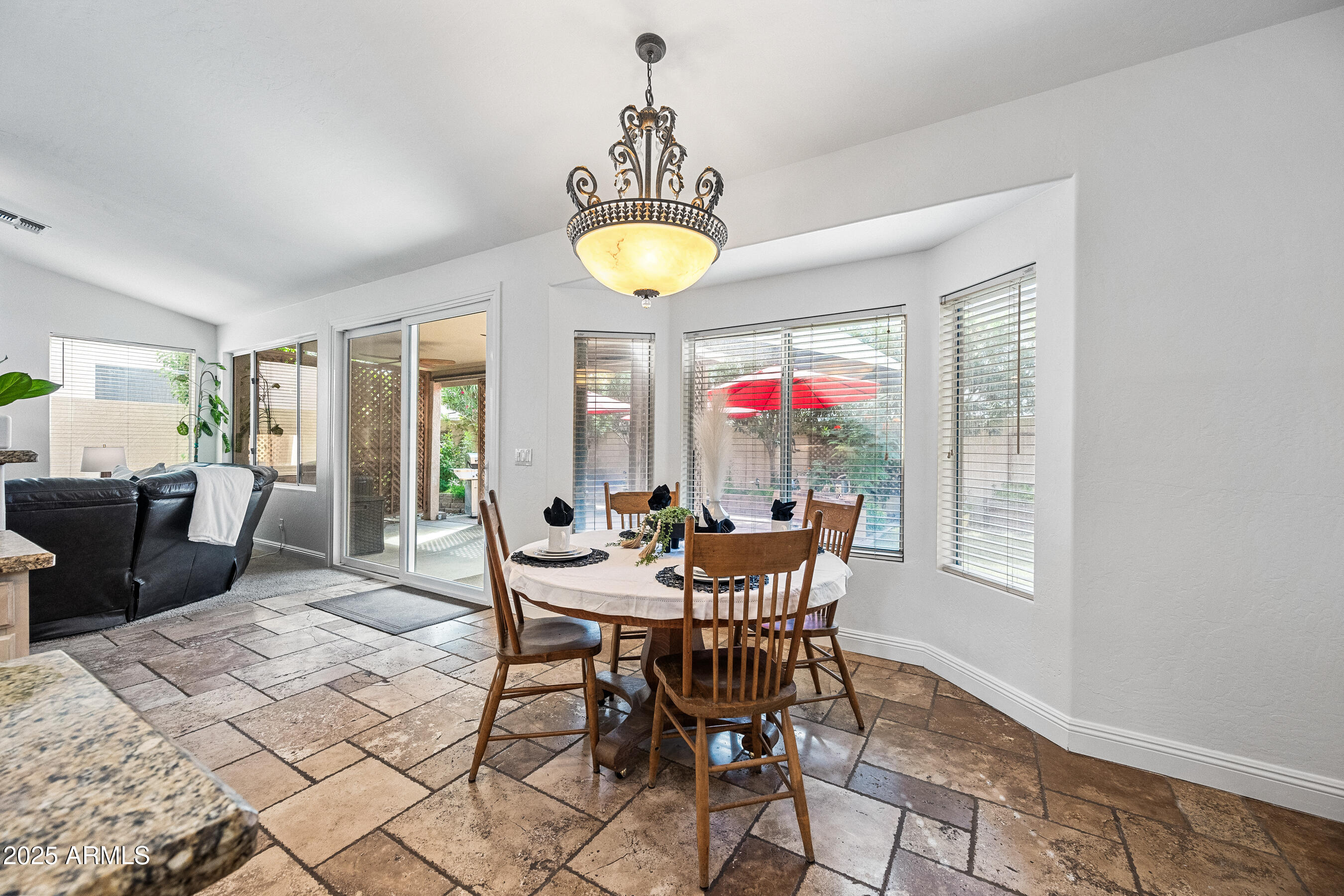 1541 West Chilton Avenue Gilbert, AZ 85233 - Photo 20 of 71 a view of a dining room with furniture and chandelier