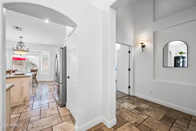 a view of a patio with a table and chairs under an umbrella