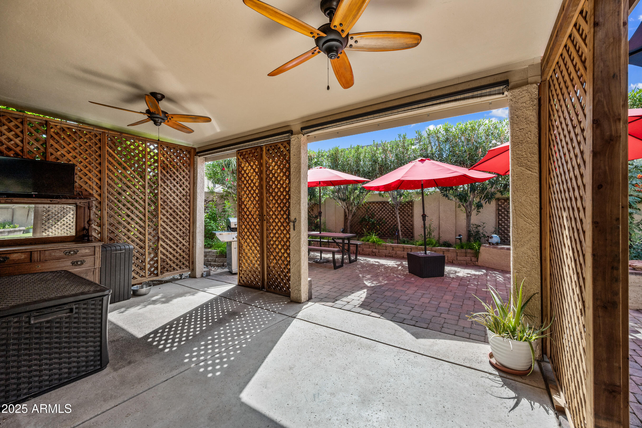 1541 West Chilton Avenue Gilbert, AZ 85233 - Photo 40 of 71 a view of a patio with a table and chairs under an umbrella