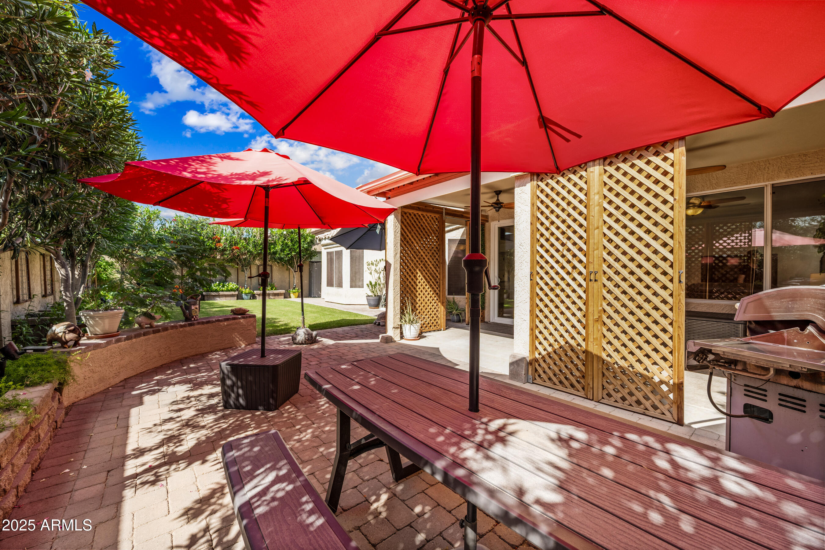 1541 West Chilton Avenue Gilbert, AZ 85233 - Photo 41 of 71 a view of a patio with a table and chairs under an umbrella