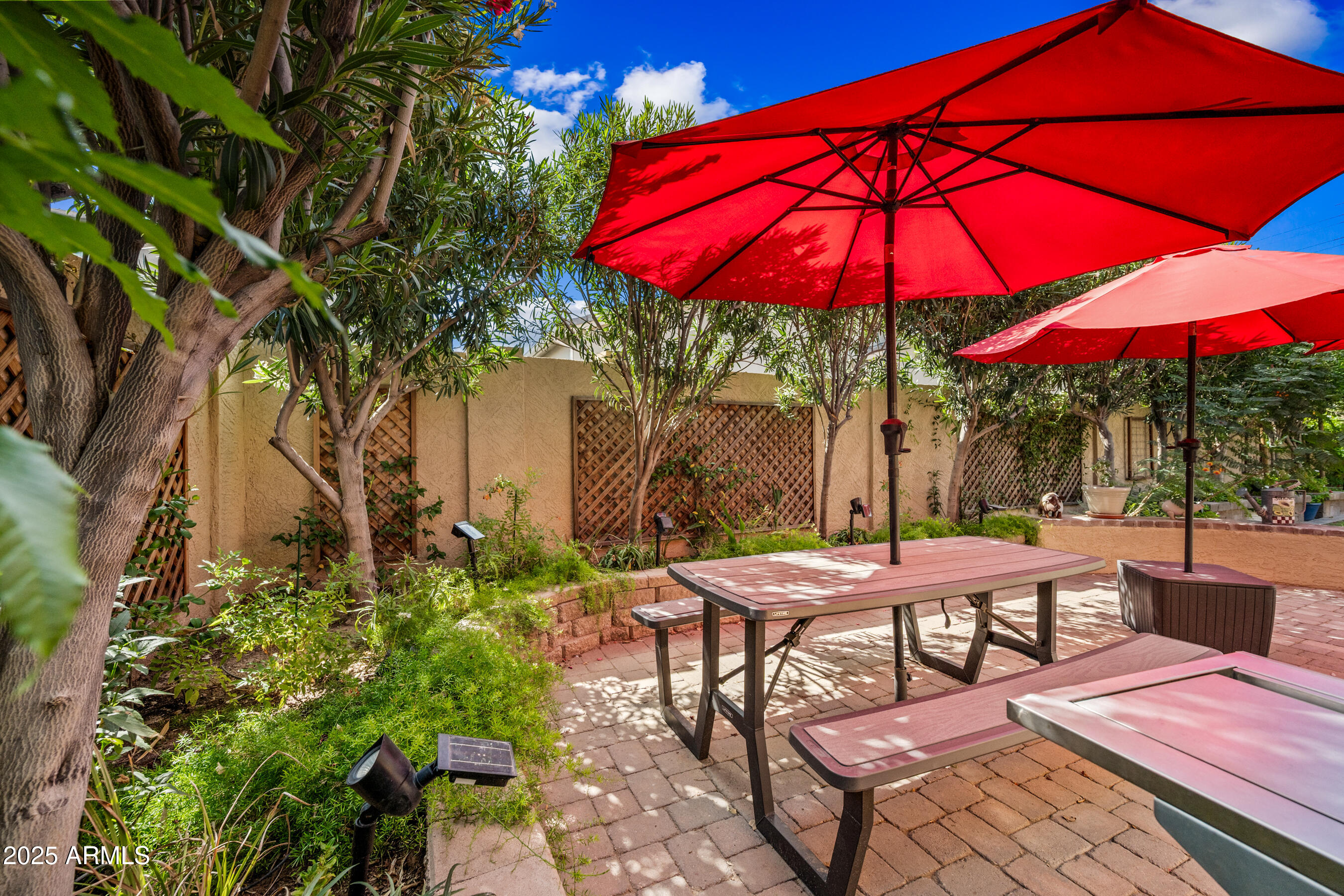 1541 West Chilton Avenue Gilbert, AZ 85233 - Photo 48 of 71 a view of a patio with a table and chairs under an umbrella
