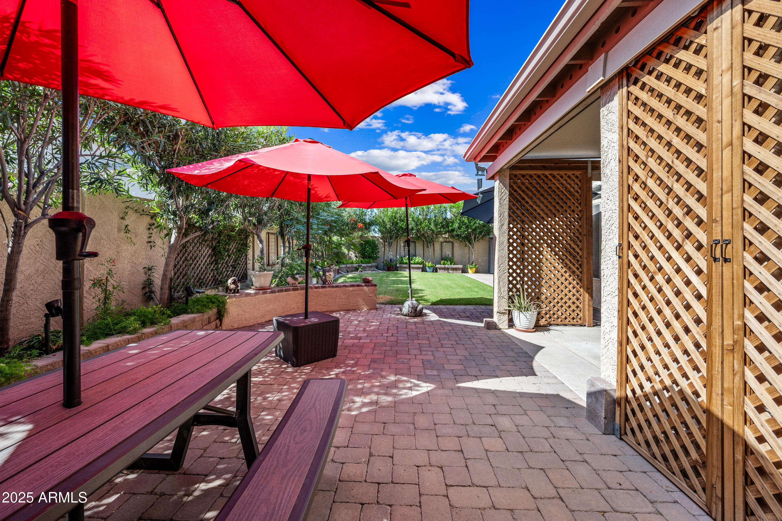 1541 West Chilton Avenue Gilbert, AZ 85233 - Photo 49 of 71 a view of a patio with table and chairs under an umbrella