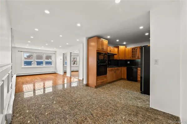 a view of a kitchen with refrigerator and kitchen