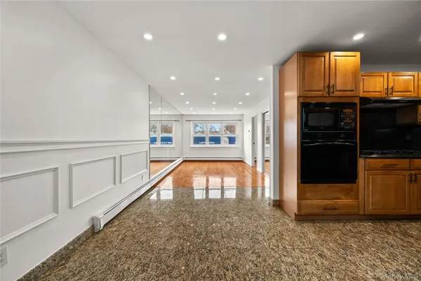 a kitchen with stainless steel appliances kitchen island granite countertop a refrigerator and a stove