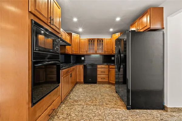 a kitchen with granite countertop cabinets stainless steel appliances and a counter space