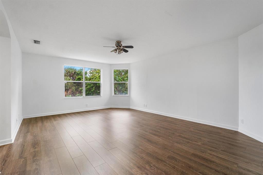 1650 Southwest 2nd Avenue Boca Raton, FL 33432 - Photo 13 of 16 an empty room with wooden floor and windows