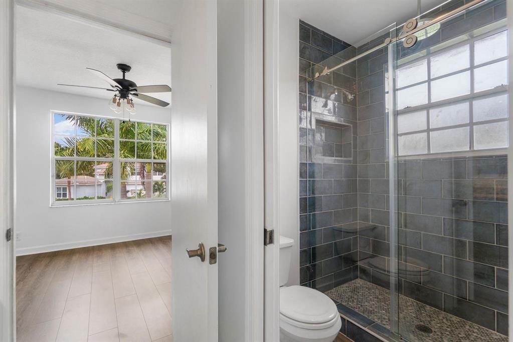 1650 Southwest 2nd Avenue Boca Raton, FL 33432 - Photo 14 of 16 a bathroom with a shower toilet and a shower
