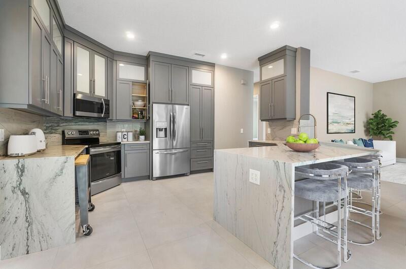 1650 Southwest 2nd Avenue Boca Raton, FL 33432 - Photo 9 of 16 a kitchen with stainless steel appliances a refrigerator sink and stove