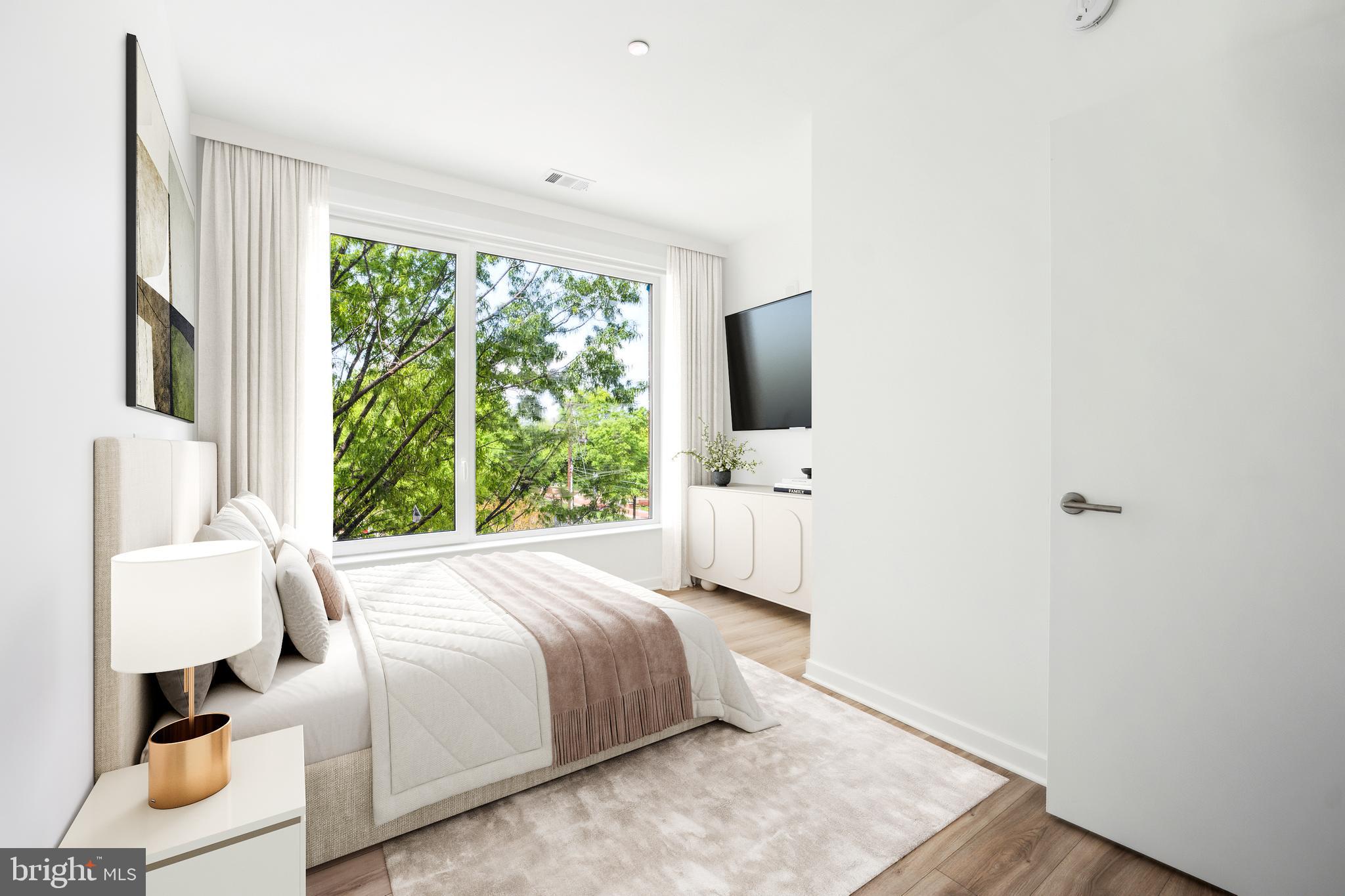 5300 Wisconsin Avenue, Unit PH10 Washington, DC 20015 - Photo 11 of 29 a bedroom with a bed wooden floor and window