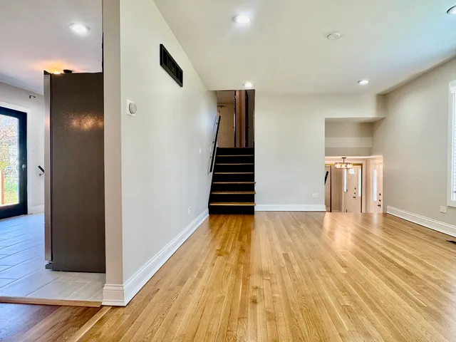 a view of a room with wooden floor and stairs
