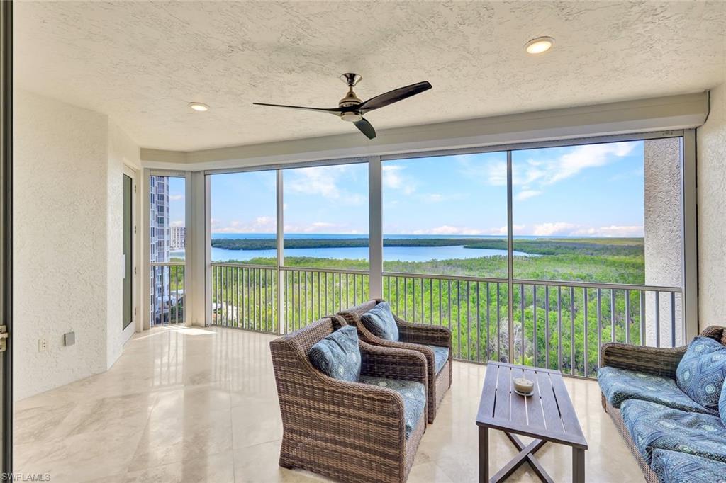 275 Indies Way, Unit 902 Naples, FL 34110 - Photo 20 of 39 a living room with furniture and a floor to ceiling window