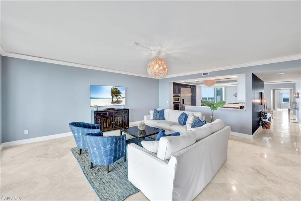 275 Indies Way, Unit 902 Naples, FL 34110 - Photo 4 of 39 a living room with furniture and painting on the wall