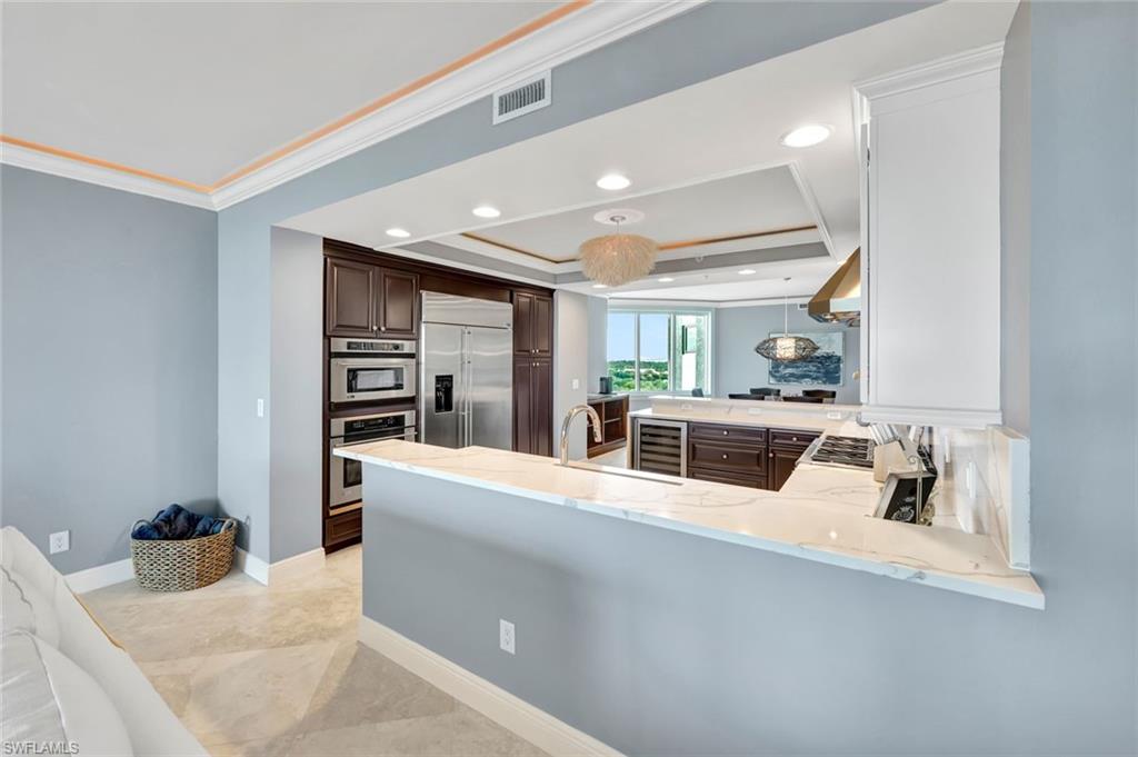 275 Indies Way, Unit 902 Naples, FL 34110 - Photo 6 of 39 a room with furniture and a flat screen tv