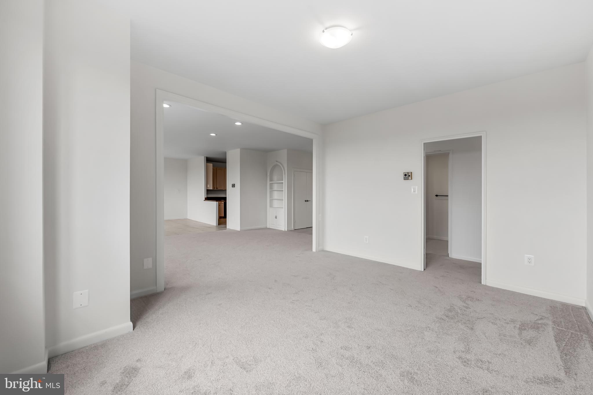 11 Slade Avenue, Unit 911 Baltimore, MD 21208 - Photo 12 of 32 an empty room with an entryway and an entrance