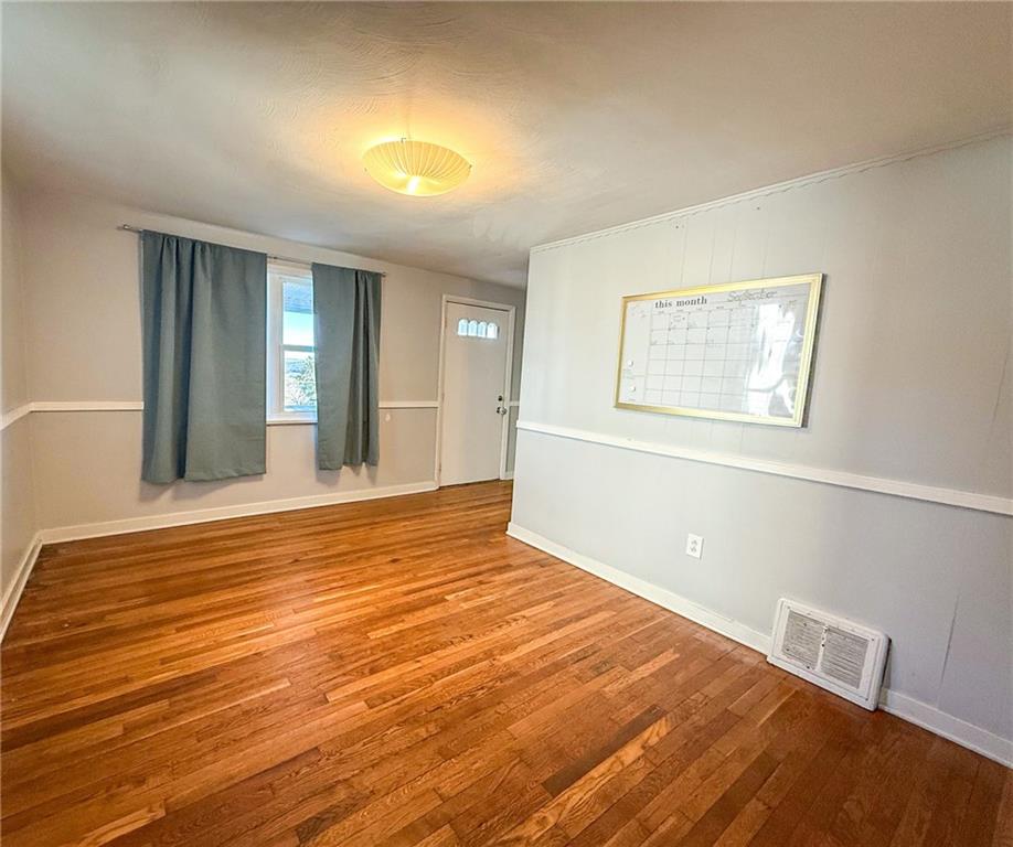 201 Wallula Avenue Butler, PA 16001 - Photo 12 of 41 a view of an empty room with wooden floor and a window