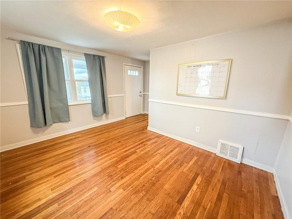 201 Wallula Avenue Butler, PA 16001 - Photo 14 of 41 a view of an empty room with wooden floor and a window