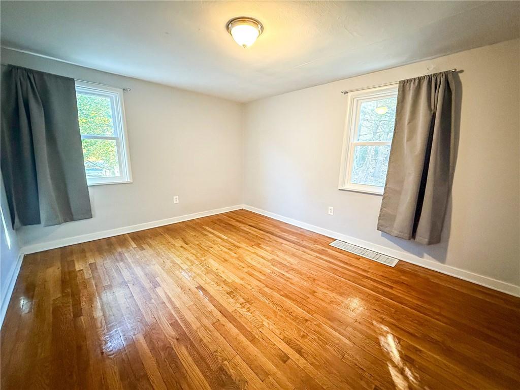 201 Wallula Avenue Butler, PA 16001 - Photo 18 of 41 a view of an empty room with wooden floor and a window