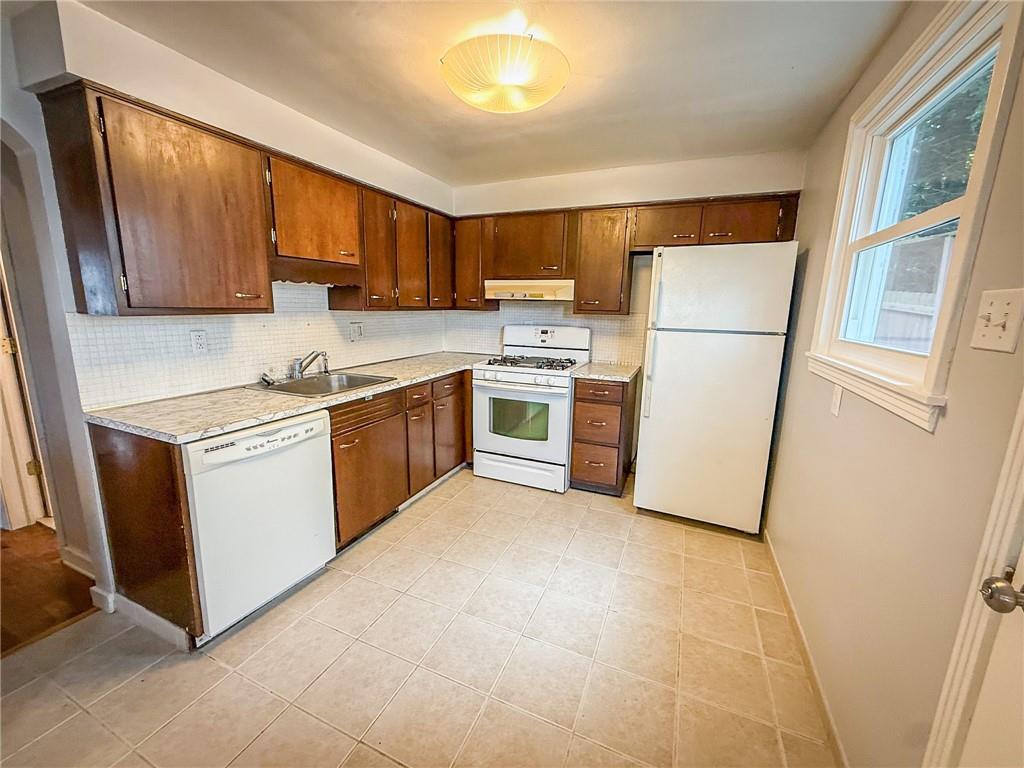 201 Wallula Avenue Butler, PA 16001 - Photo 6 of 41 a kitchen with a sink a refrigerator a microwave a sink and cabinets