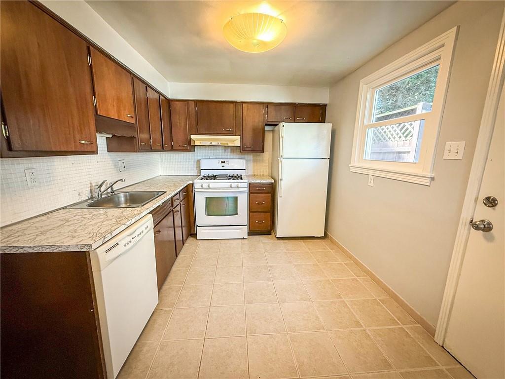 201 Wallula Avenue Butler, PA 16001 - Photo 9 of 41 a kitchen with a sink a refrigerator and a stove top oven