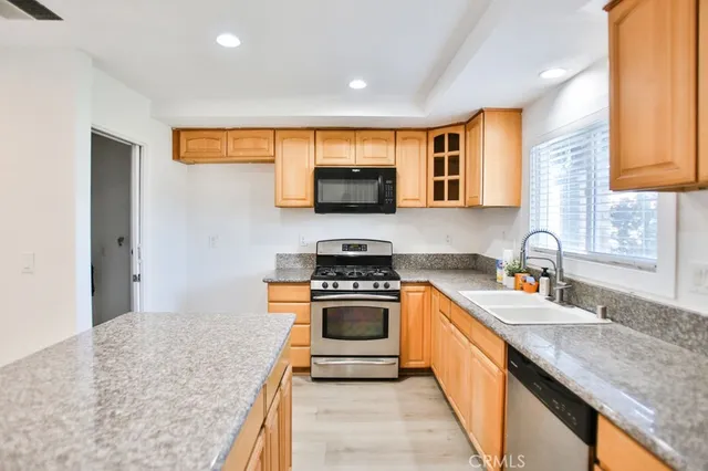 a kitchen with stainless steel appliances granite countertop a stove and a sink
