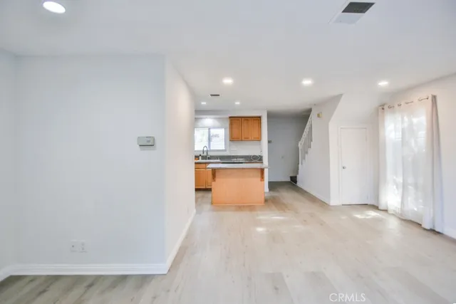 a view of a kitchen with a sink and a refrigerator