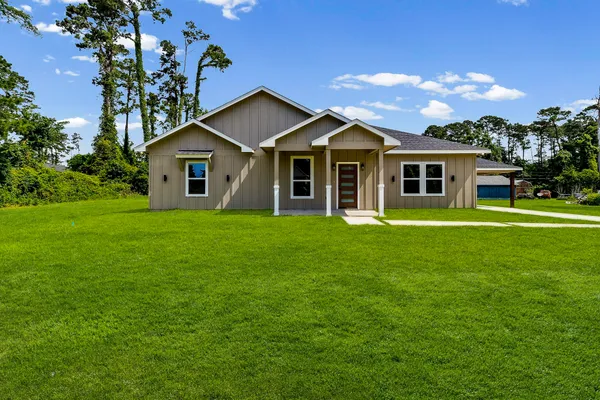 a front view of house with yard and green space