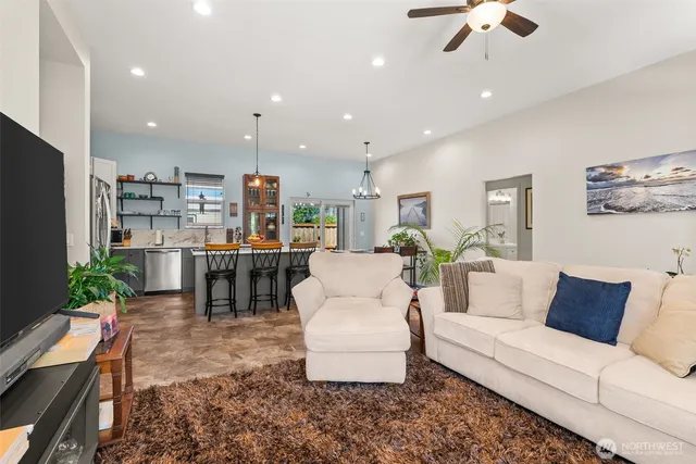 a living room with furniture and kitchen view