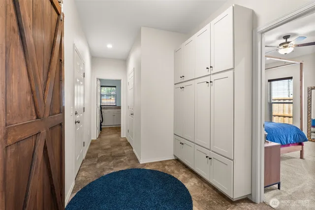 a spacious bedroom with a bed and a large mirror