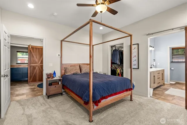 a bedroom with a large bed and a chandelier
