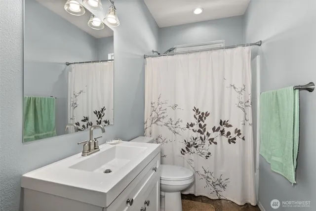 a kitchen with granite countertop wooden cabinets and a sink