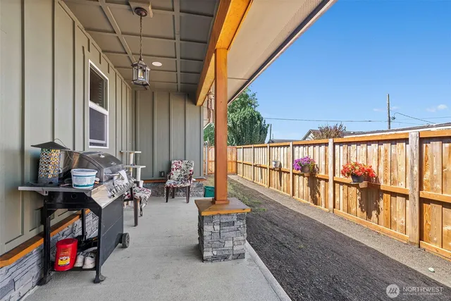 a view of a chair and fire pit in the backyard
