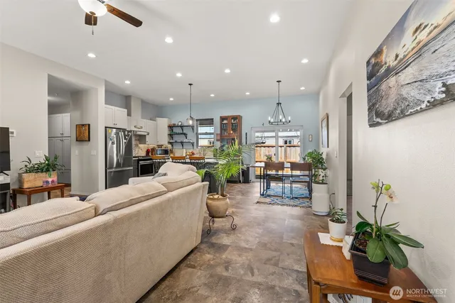 a living room with furniture and a dining table