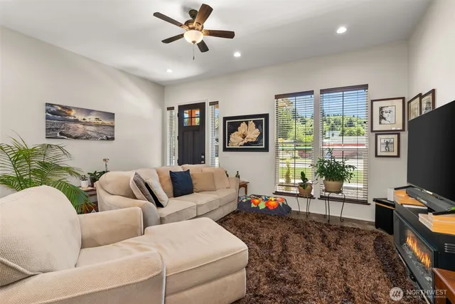 a living room with furniture a window and a flat screen tv