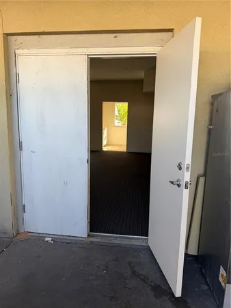 a view of an empty room with a mirror